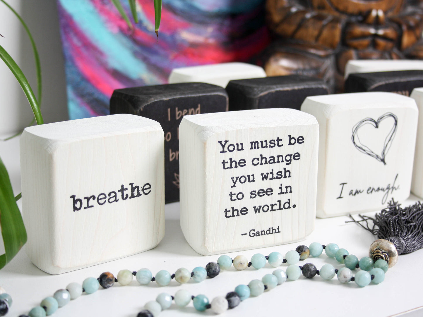 series of yoga themed blocks, the focused one says "you must be the change you wish to see in the world - gandhi"