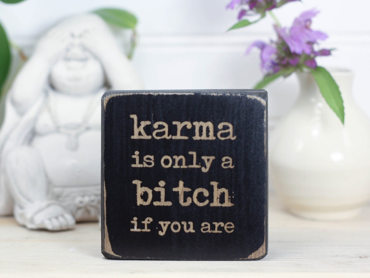Small but sassy freestanding decor in distressed black with the saying "Karma is only a bitch if you are".
