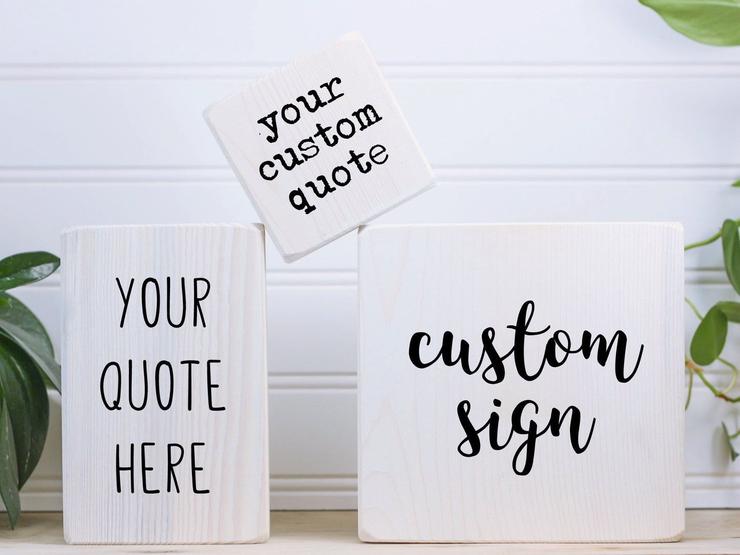 3 different sized wood block signs with different fonts