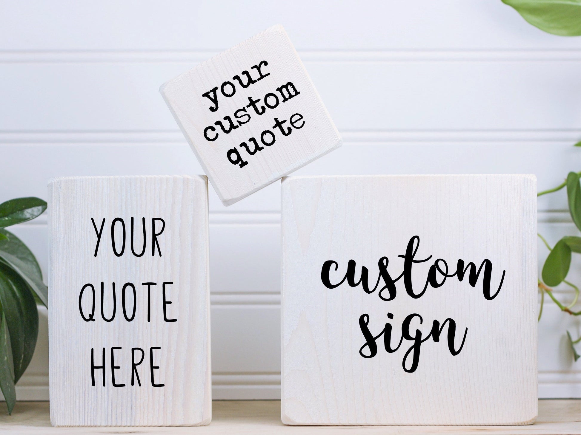 3 different sized wood block signs with different fonts
