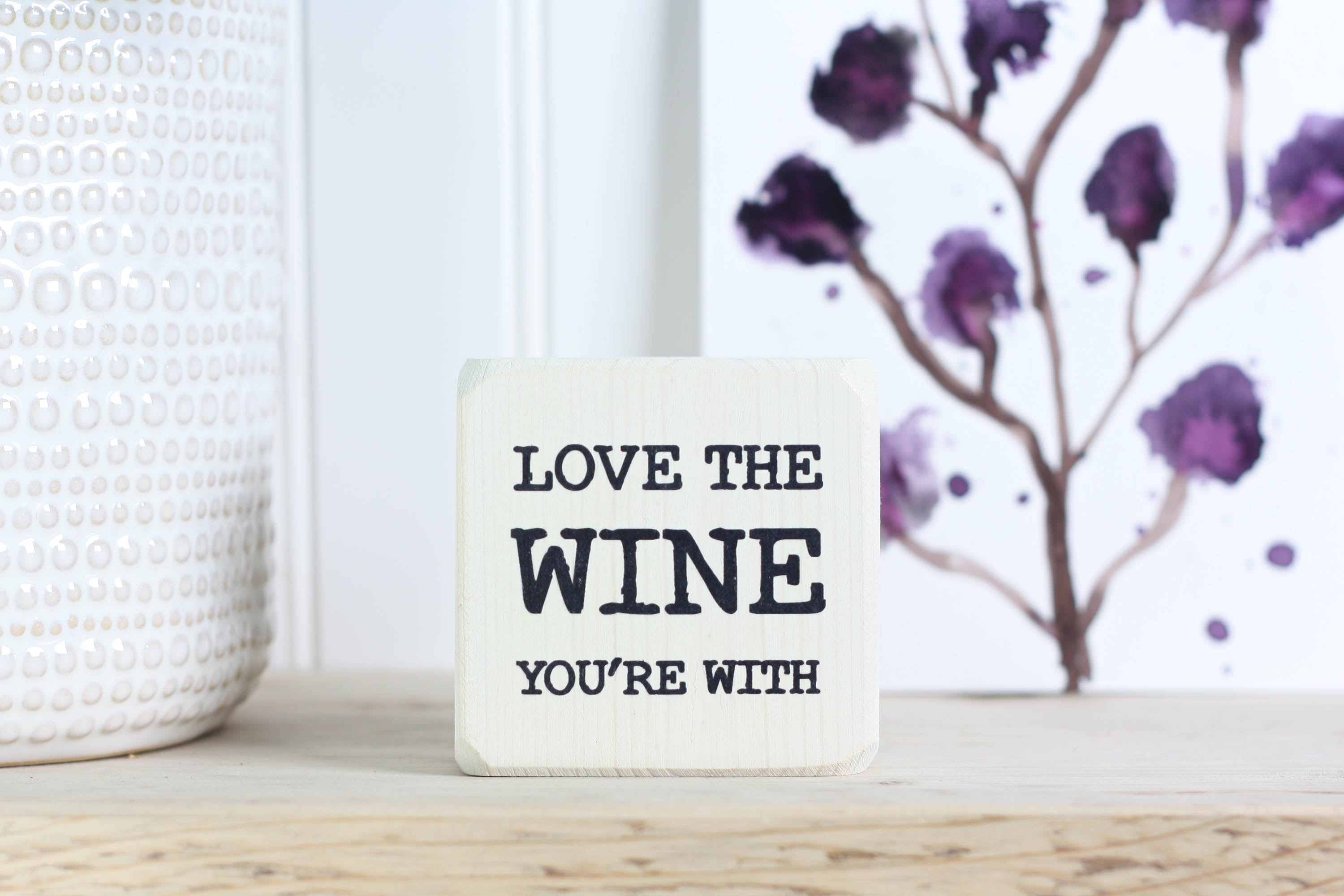 Mini wood bar sign in whitewash with the saying "Love the wine you're with".