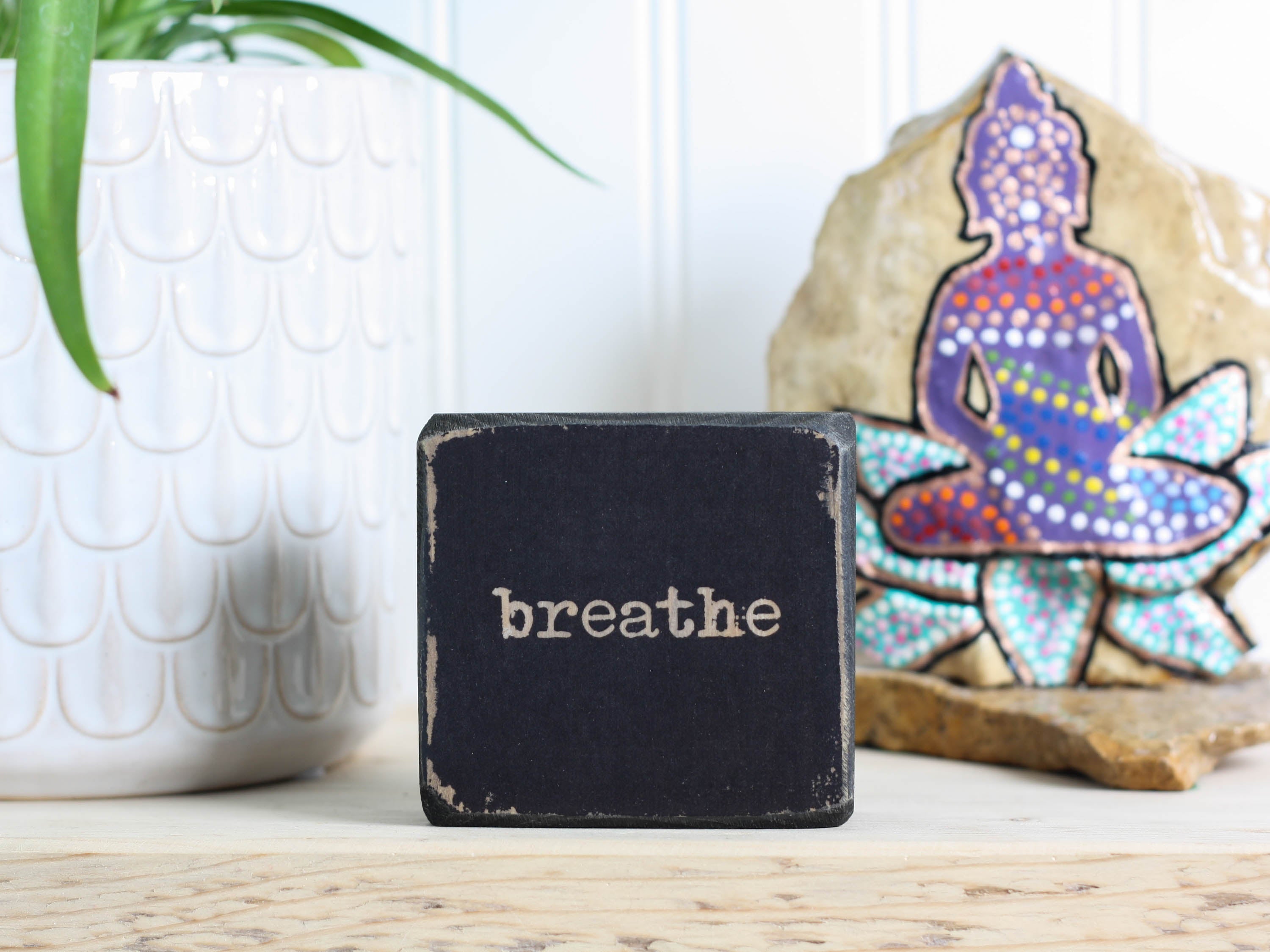 Small wood yoga meditation sign in distressed black with the word "Breathe".