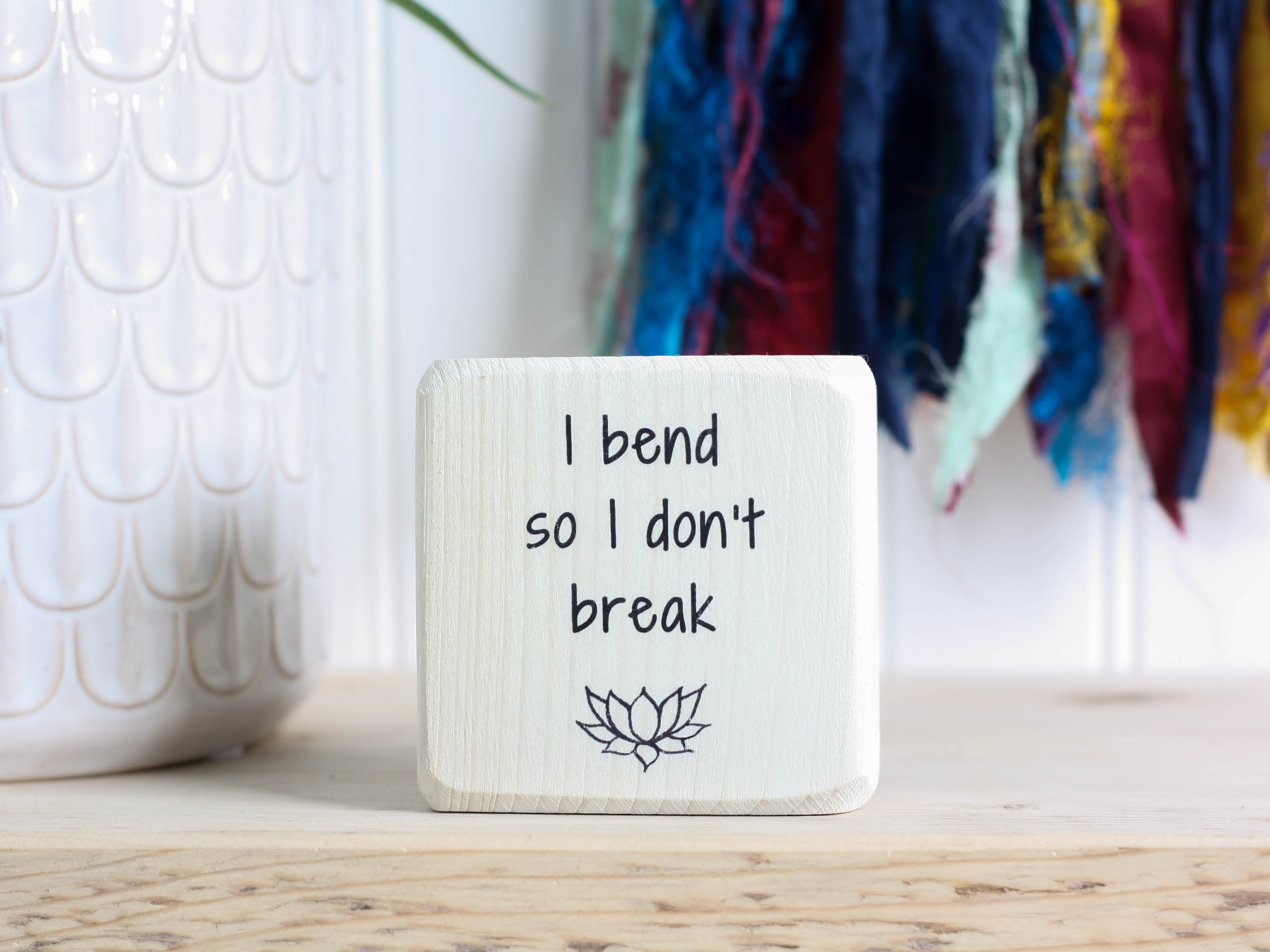 Mini wood yoga decor in whitewash with the saying "I bend so I don't break".