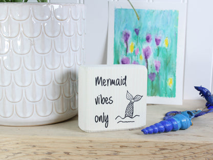 Small whitewashed wood sign with the text "mermaid vibes only" and a mermad tail