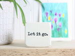 Small wood inspirational sign in whitewash with the saying "Let it go."