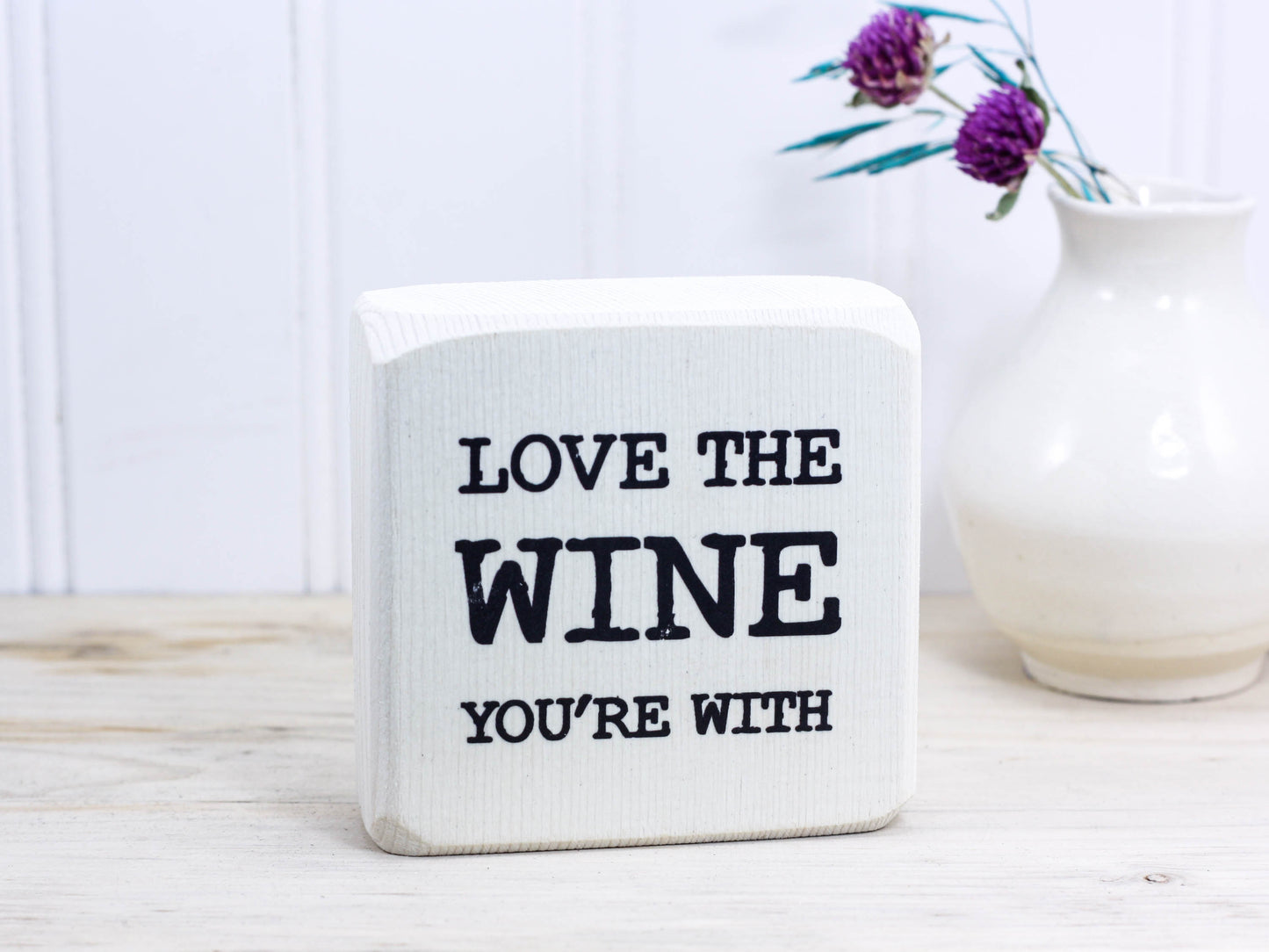 Mini wood bar sign in whitewash with the saying "Love the wine you're with".