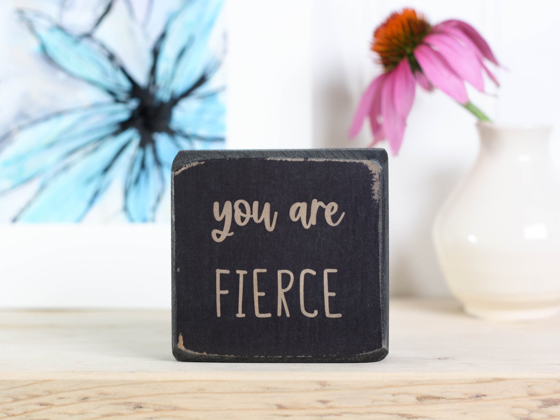 Small, freestanding, distressed black, solid wood sign with saying "you are fierce"