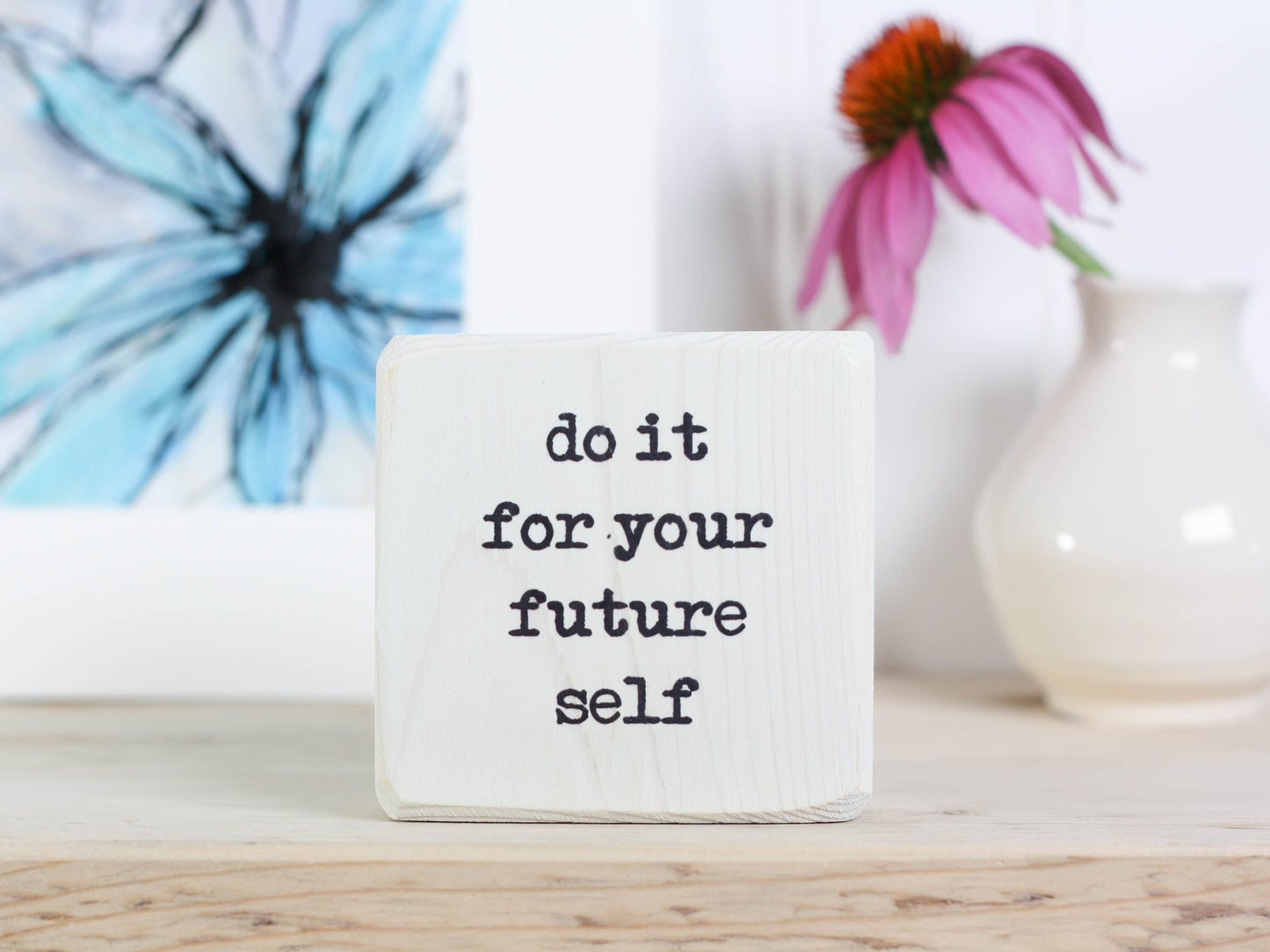 Small, freestanding, whitewash, solid wood sign with saying "do it for your future self".