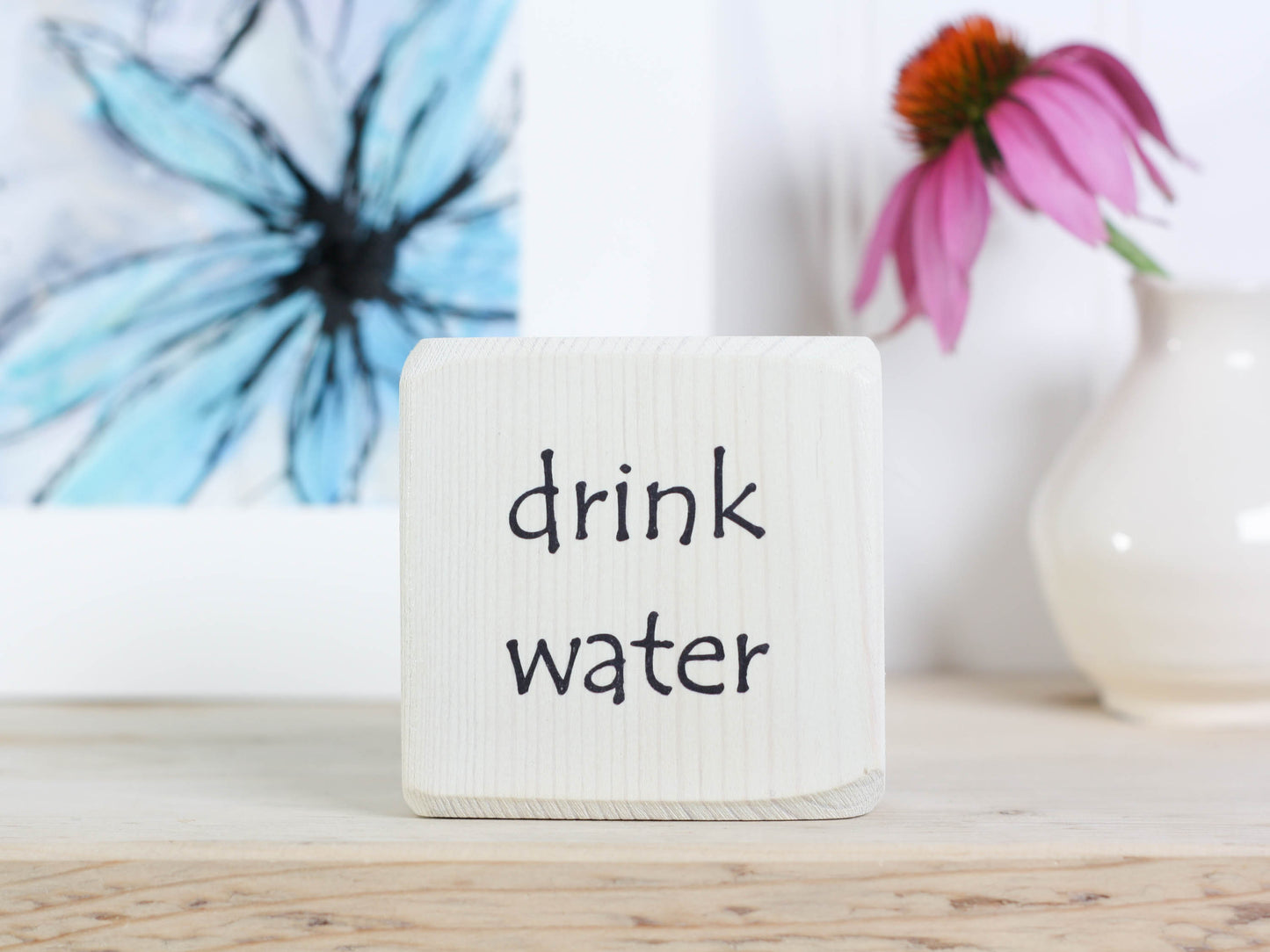 Small wood whitewashed sign with the words "drink water"