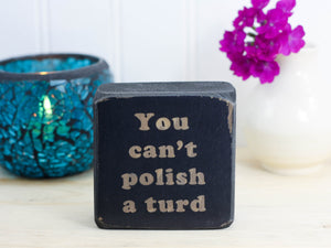 mini distressed black wood sign with the text "you can't polish a turd"