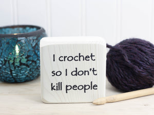 mini wood sign in whitewash with the text  "I crochet so I don't kill people"