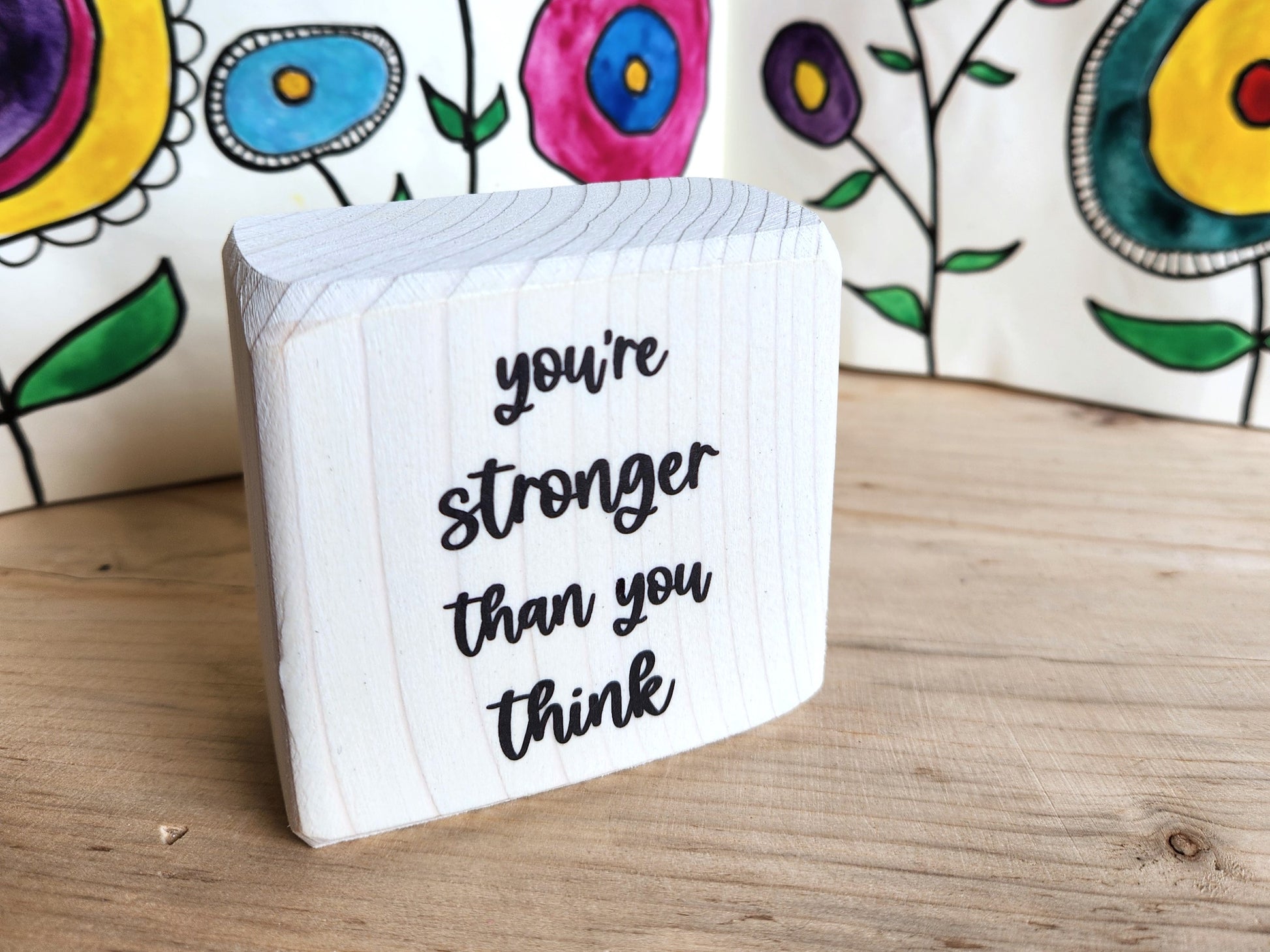 mini wood block sign with 'you're stronger than you think' text 

