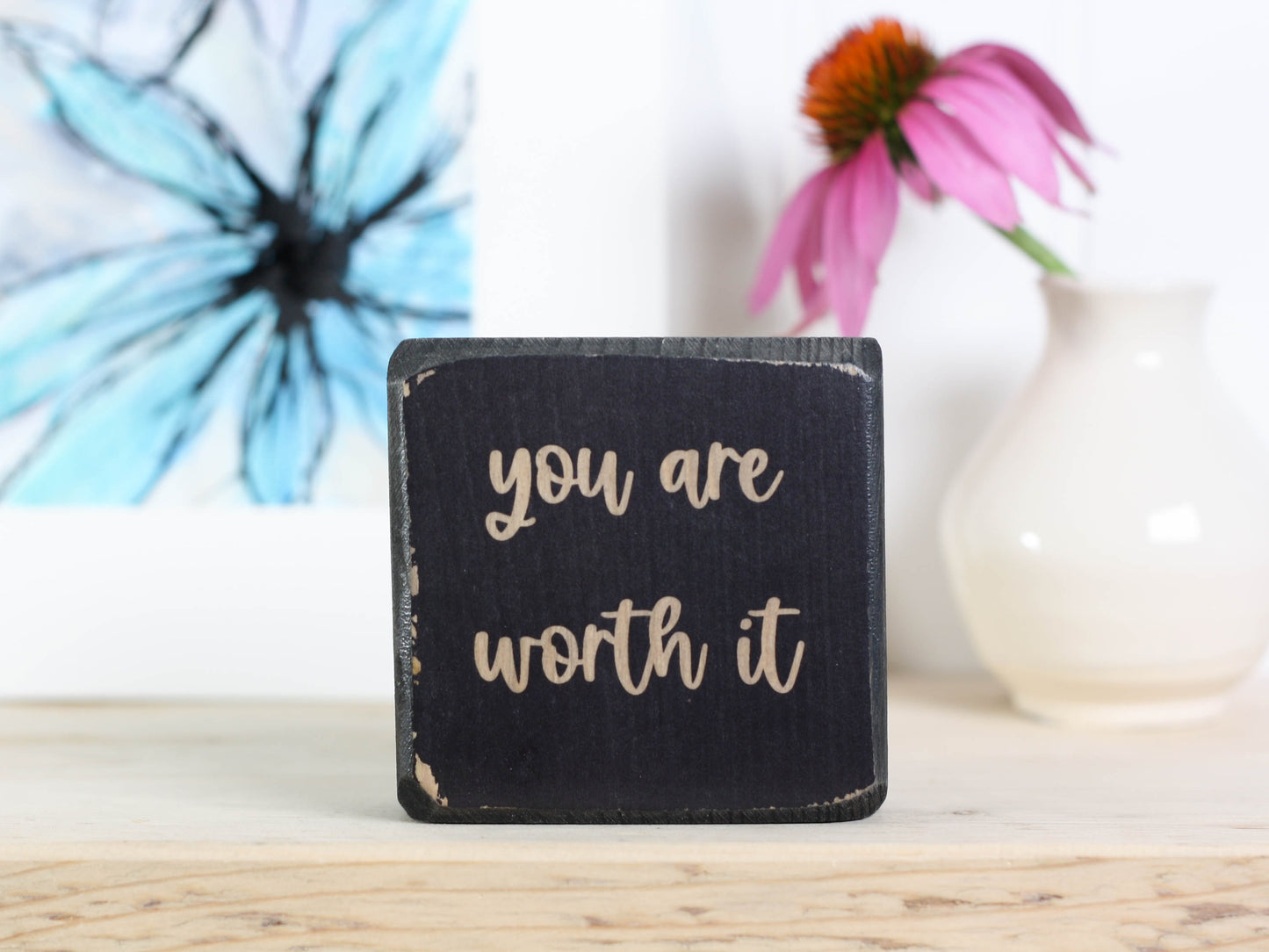 Small, freestanding, distressed black, solid wood sign with saying "you are worth it"