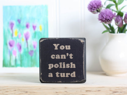 mini distressed black wood sign with the text "you can't polish a turd"