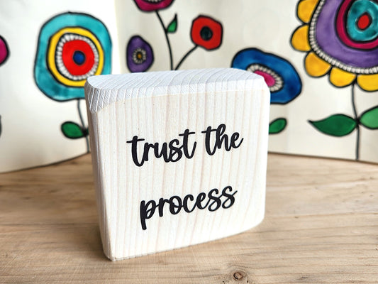 small wooden block sign with 'trust the process' 