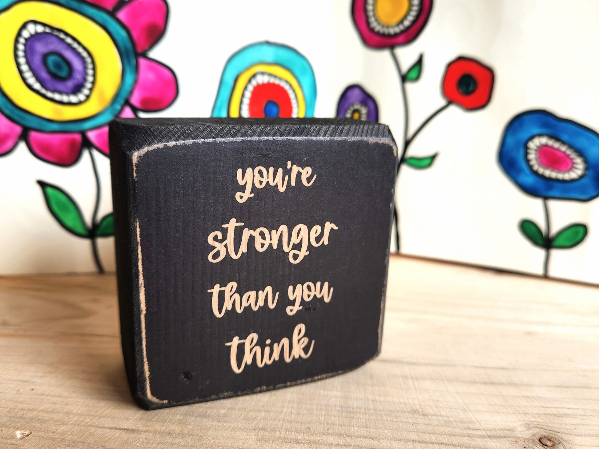 Black mini wood sign with 'you're stronger than you think' quote 