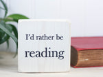 Mini wood sign in whitewash with the saying "I'd rather be reading".