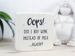 Mini wood bar sign in whitewash with the saying "Oops! Did I buy wine instead of milk...again?"