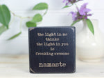 Mini wood quote block in distressed black with the saying "The light in me thinks the light in you is freaking awesome. Namaste."