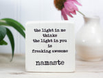 Mini wood quote block in whitewash with the saying "The light in me thinks the light in you is freaking awesome. Namaste."