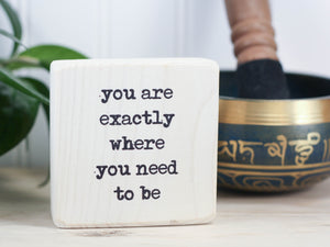 Mini wood sign in whitewash with the saying "You are exactly where you need to be".
