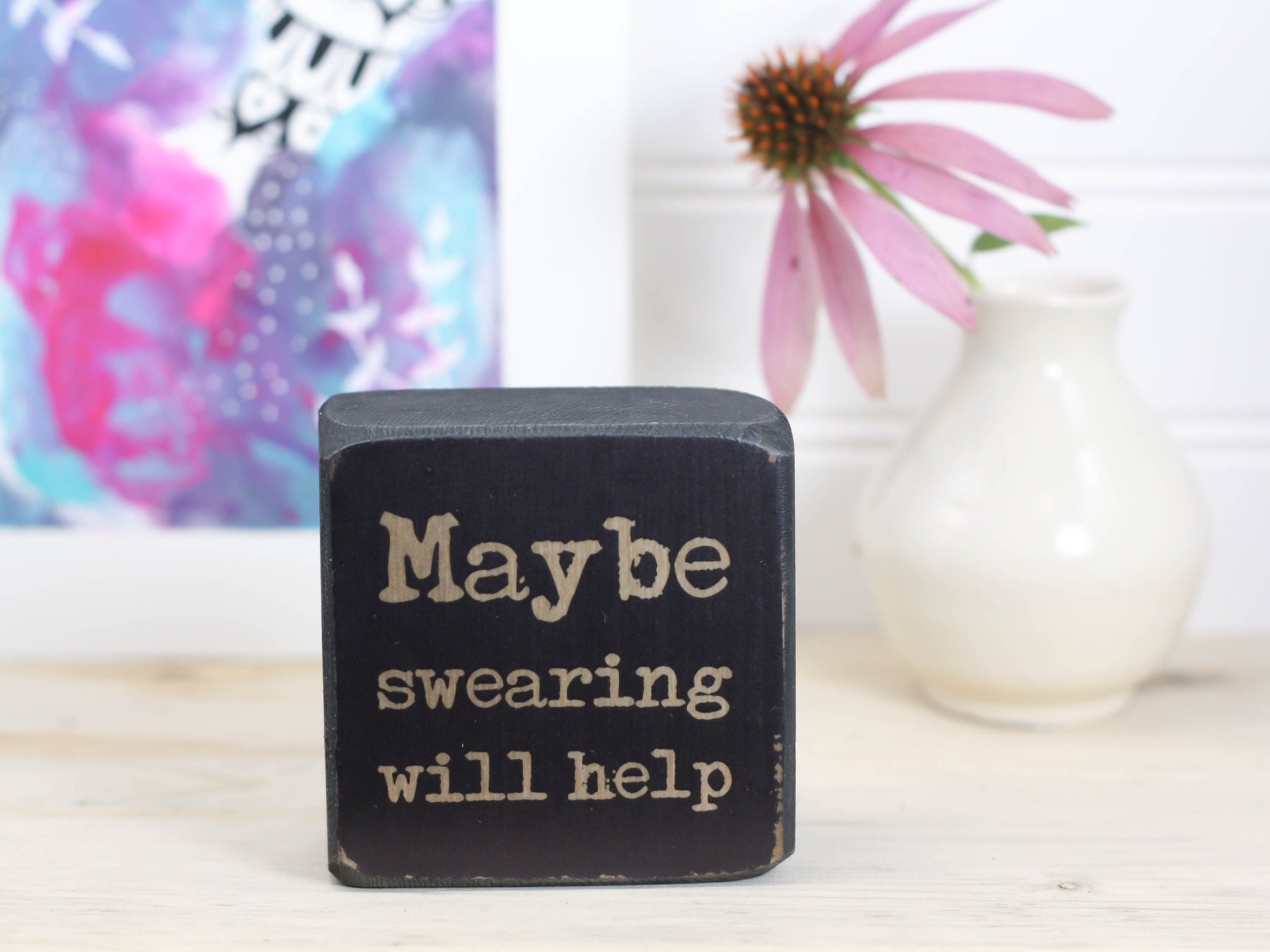 Small quote block in distressed black with the saying "Maybe swearing will help".