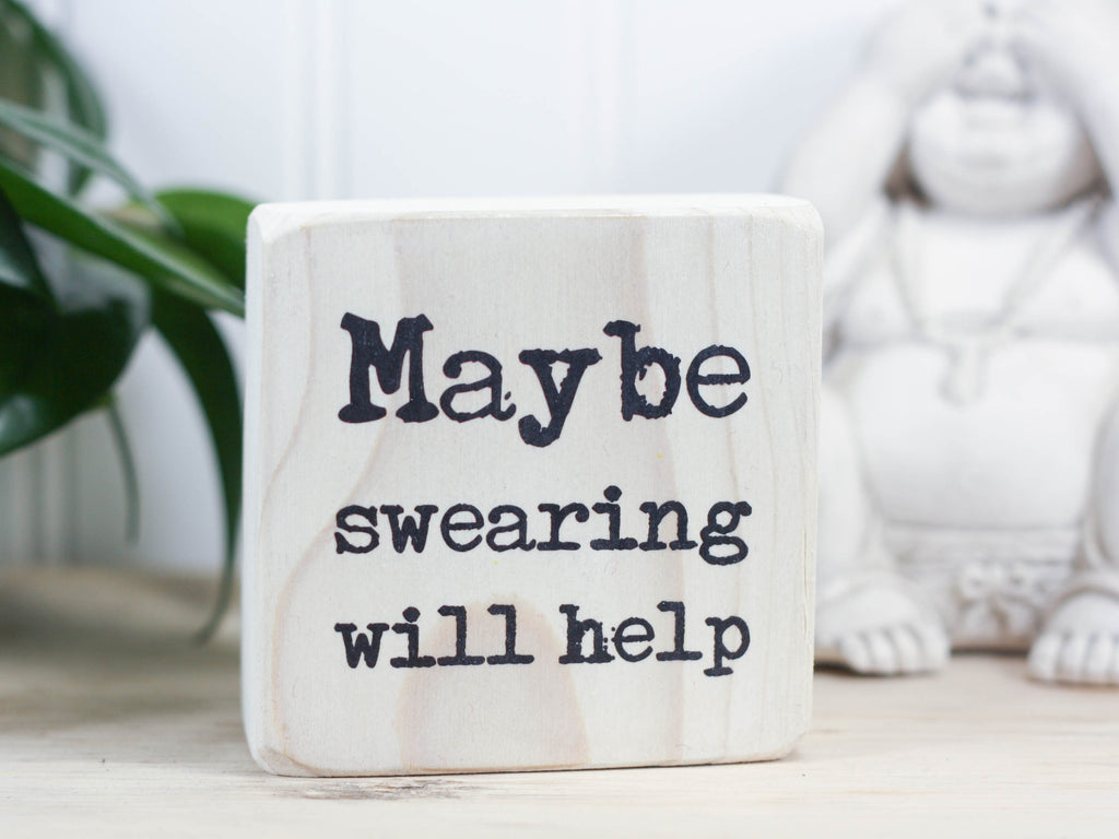 Small quote block in whitewash with the saying "Maybe swearing will help".