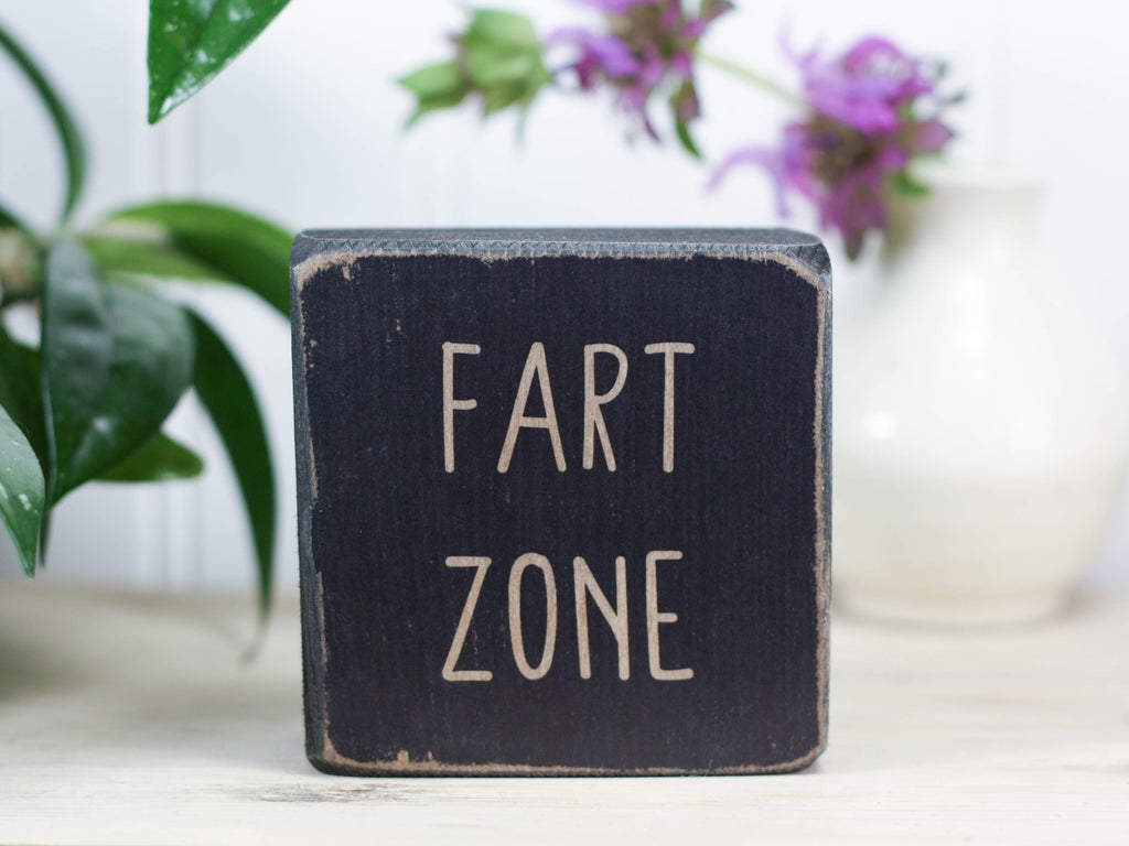 Small, freestanding, distressed black, solid wood sign with funny "fart zone" saying.