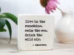 Mini wood decor in whitewash with the saying "Live in the sunshine. swim in the sea. drink the wild air. - emerson"