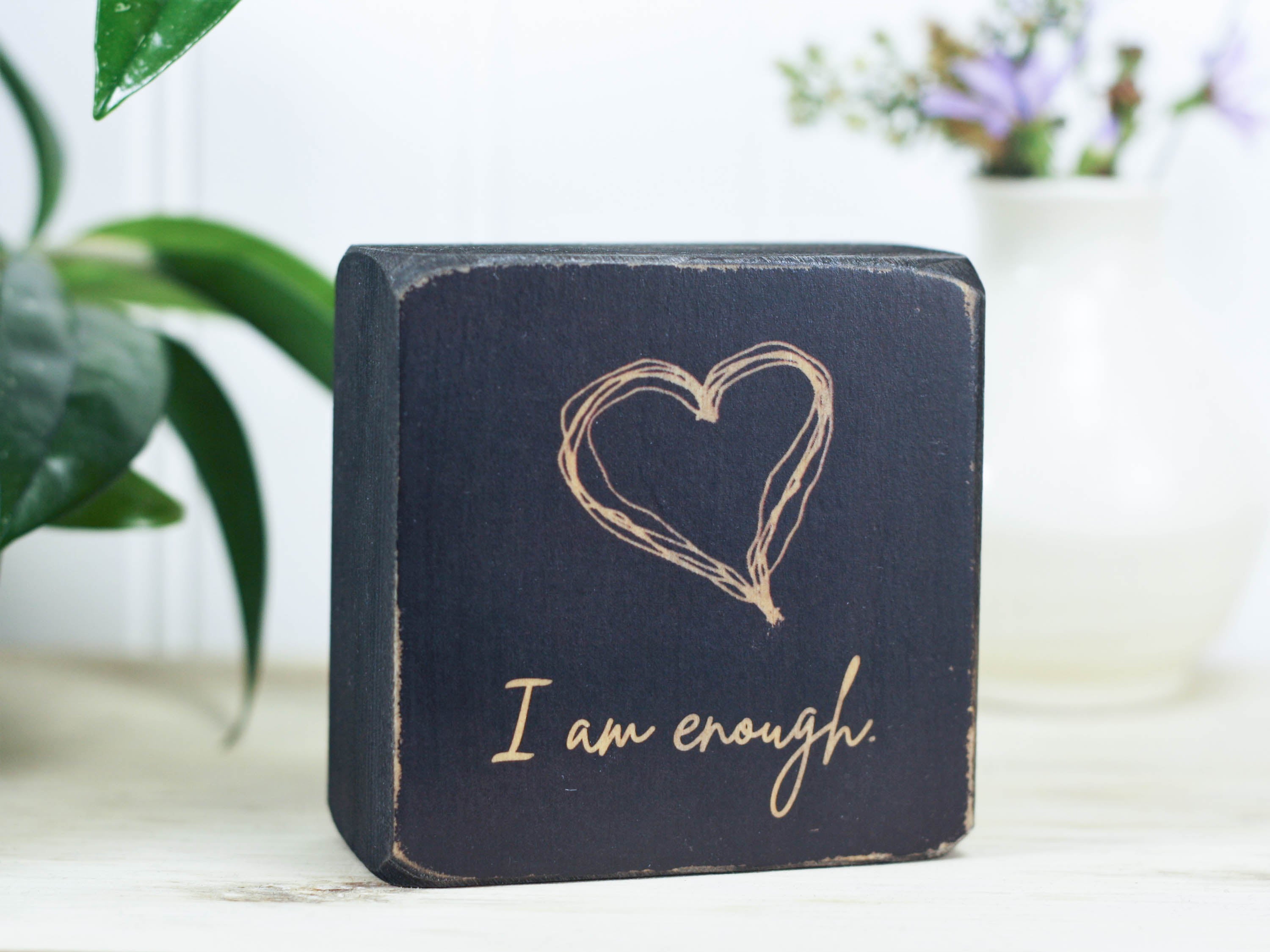Small, freestanding, distressed black, solid wood sign with saying "I am enough".