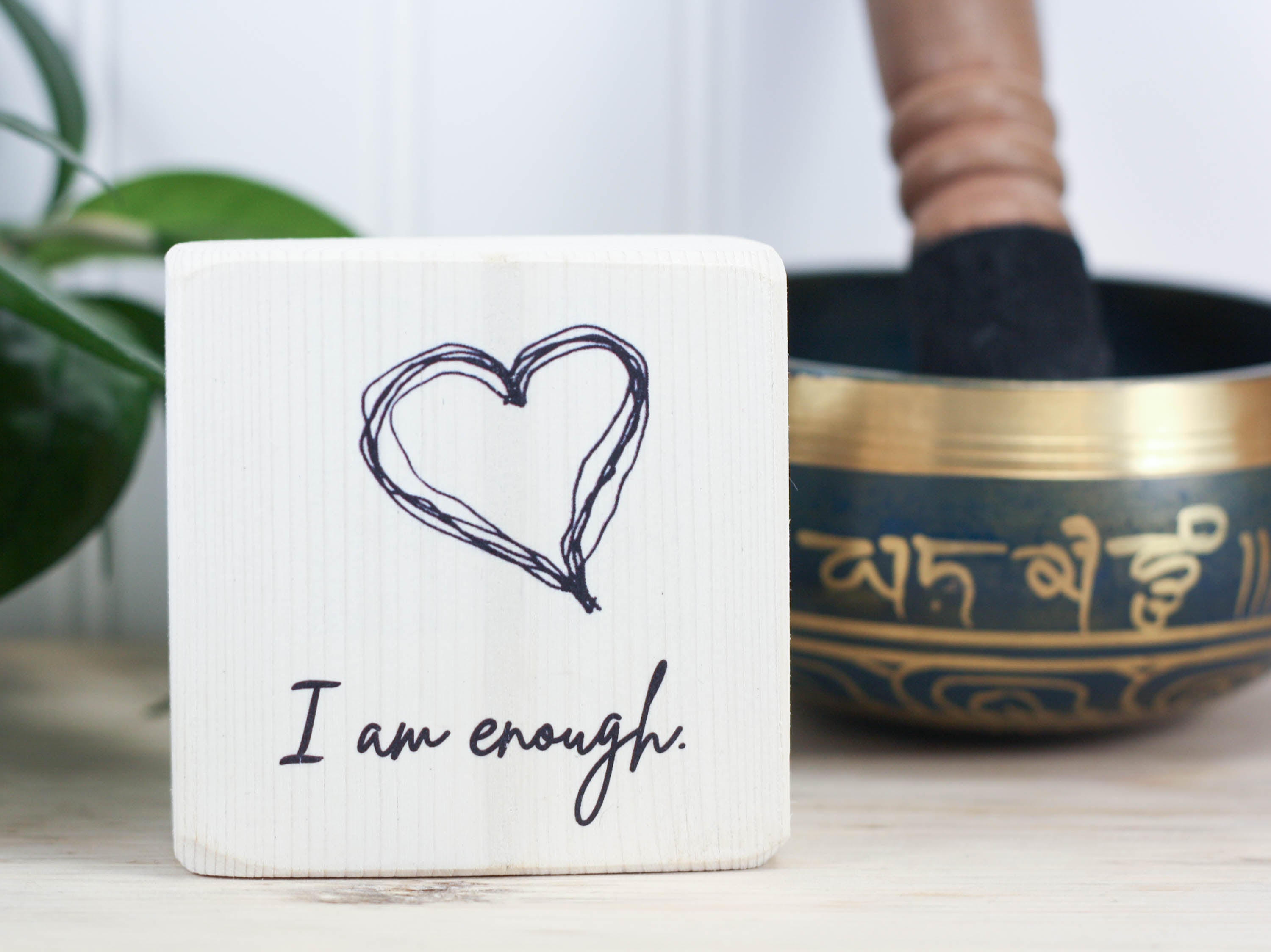 Small, freestanding, whitewash, solid wood sign with saying "I am enough".