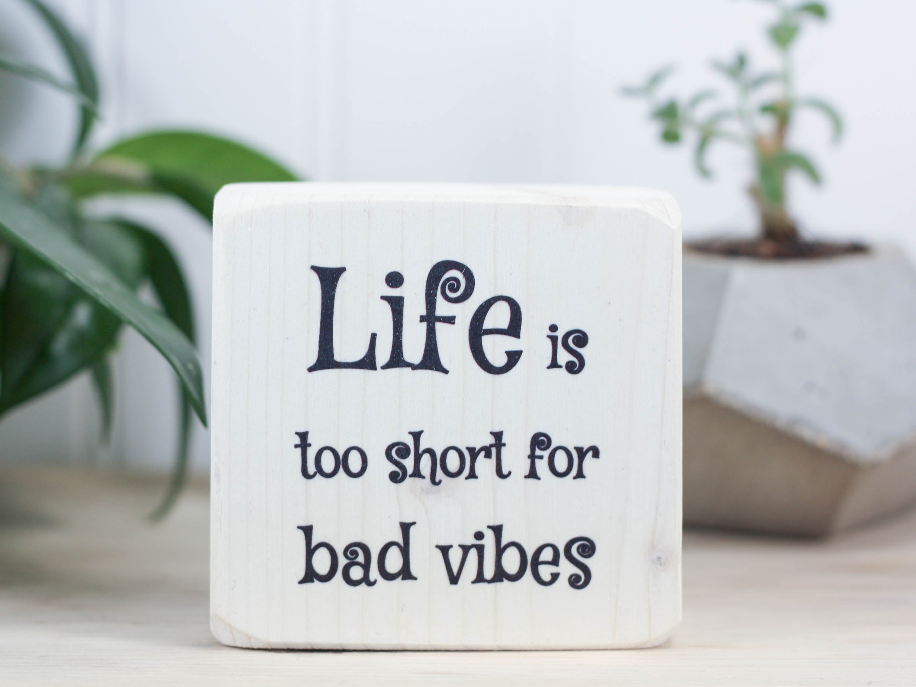 Mini wood sign in whitewash with the saying "Life is too short for bad vibes".