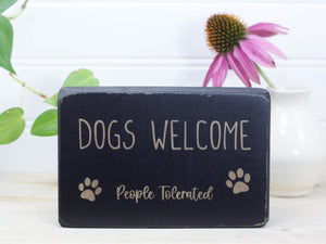 Mini wood sign in distressed black with the saying 'Dogs welcome (People tolerated)".