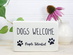 Mini wood sign in whitewash with the saying 'Dogs welcome (People tolerated)".