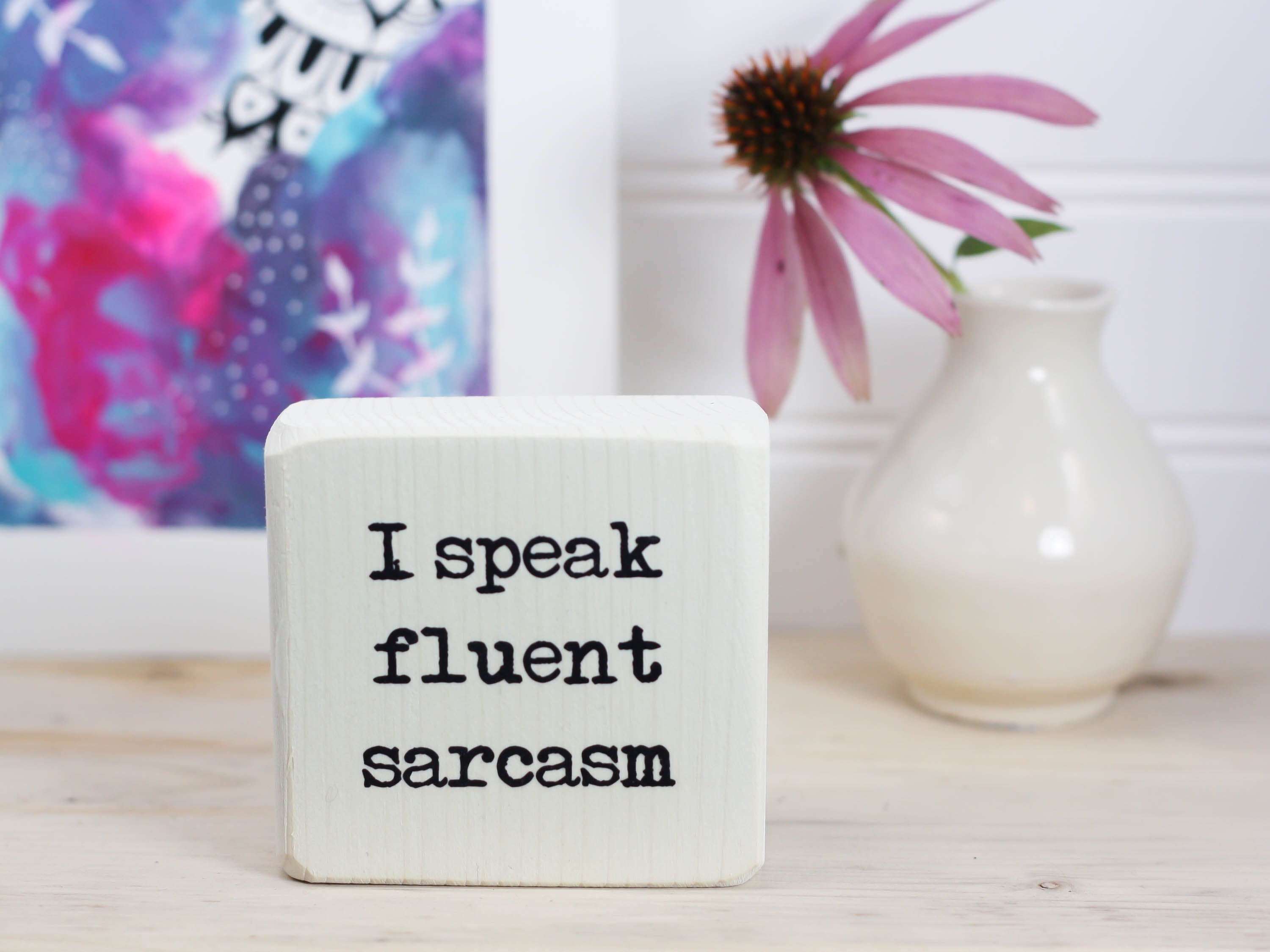 Mini wood sign in whitewash with the saying "I speak fluent sarcasm".
