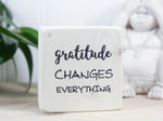 Inspirational mini wood block in whitewash with the saying "Gratitude changes everything".