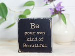 Small freestanding shelf decor in distressed black with the saying "Be your own kind of Beautiful".