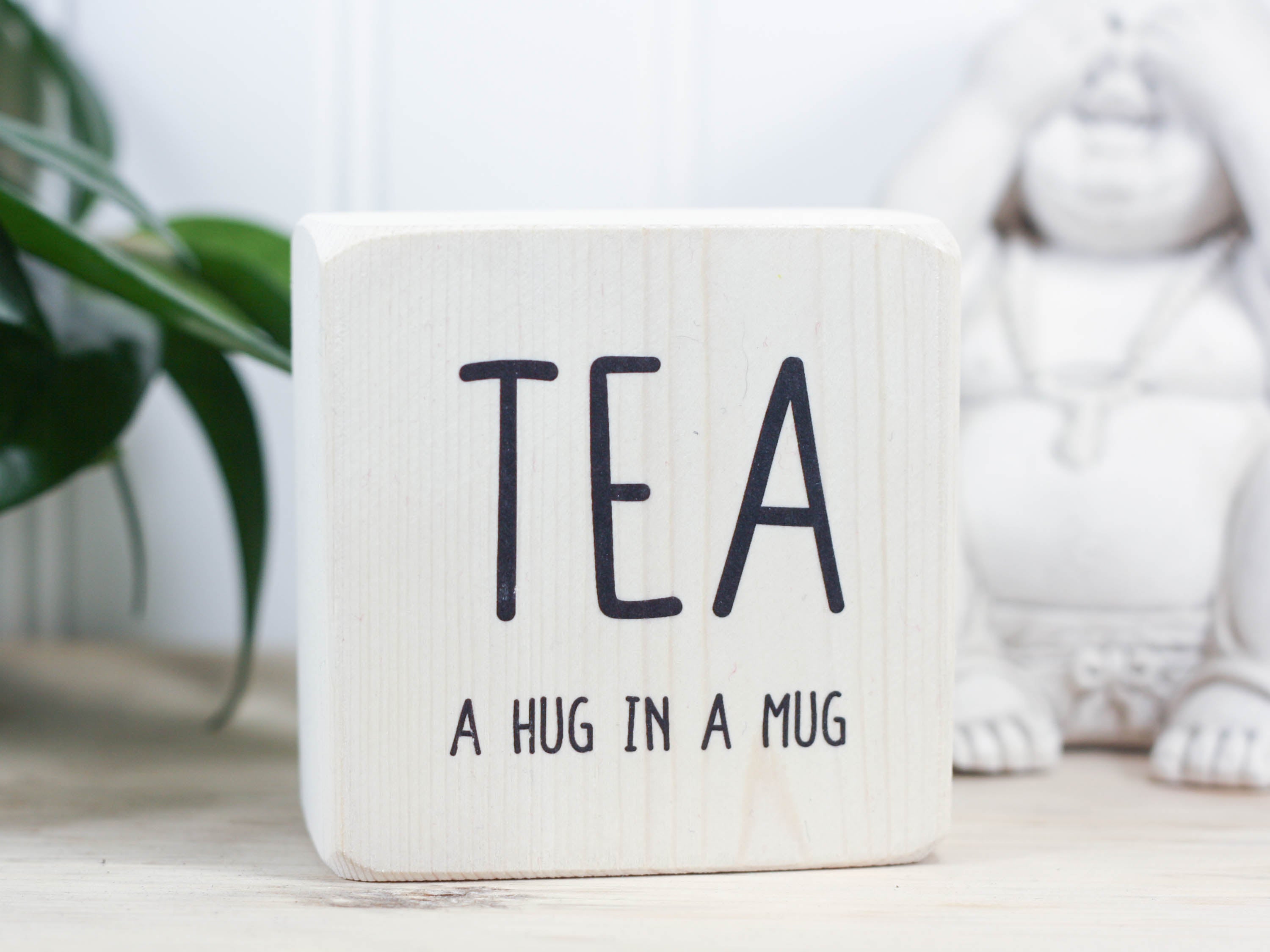 Mini wood sign in whitewash with the saying "TEA a hug in a mug".