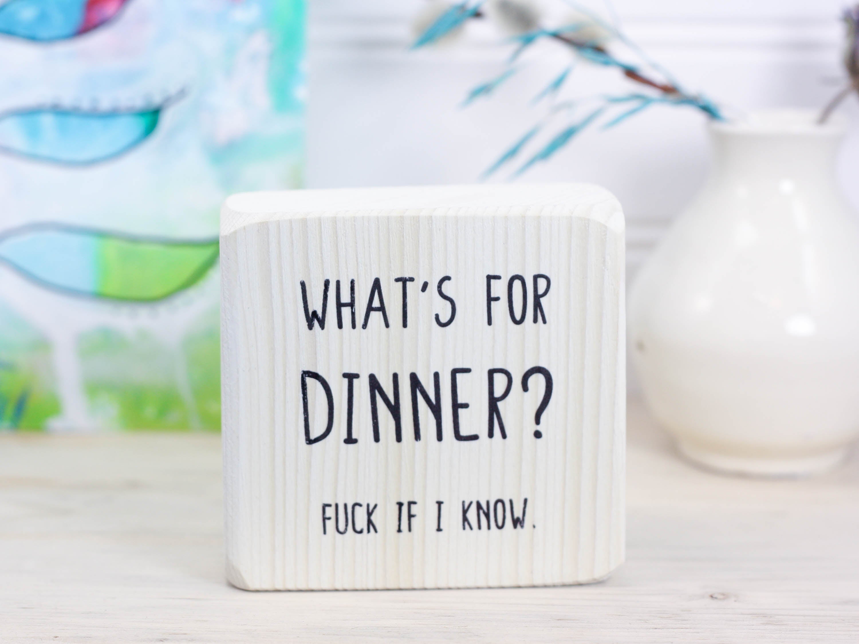 Small whitewash freestanding wood sign with the text "what's for dinner? Fuck if I know."
