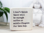 Small freestanding wood sign in whitewash with the saying "I don't think there will be enough coffee or middle fingers for this day."